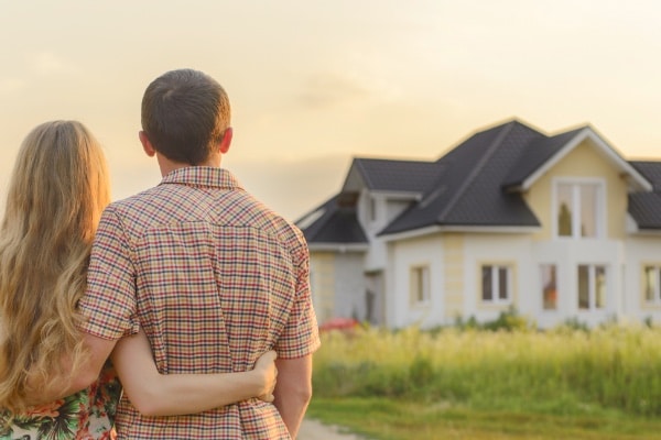 Photo Of A Couple Looking At Their Home